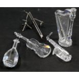 Four Swarovski crystal musical instruments, comprising harp, saxophone, cello and violin, some with