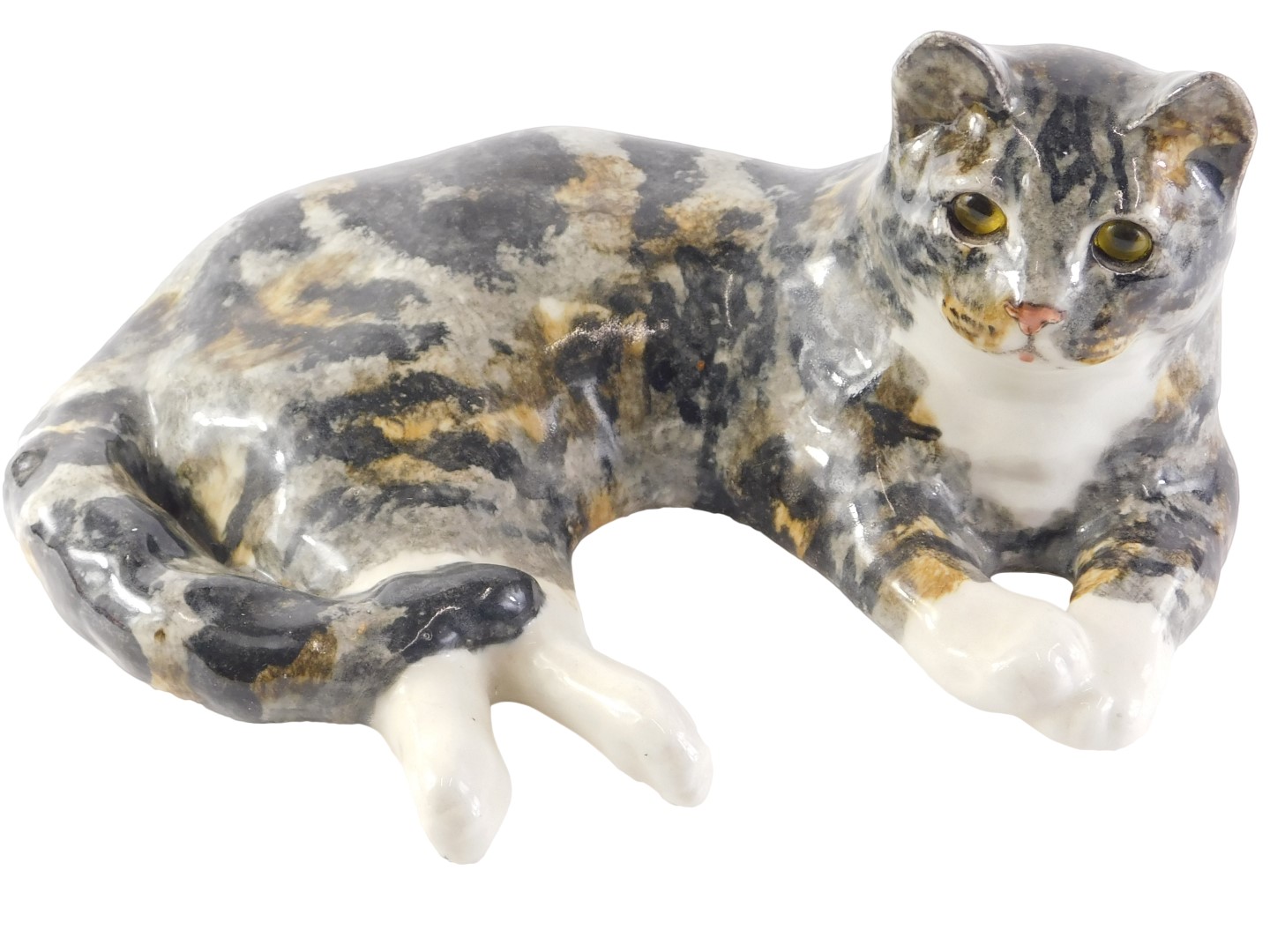 A Winstanley tabby cat, signed to underside, 36cm long.
