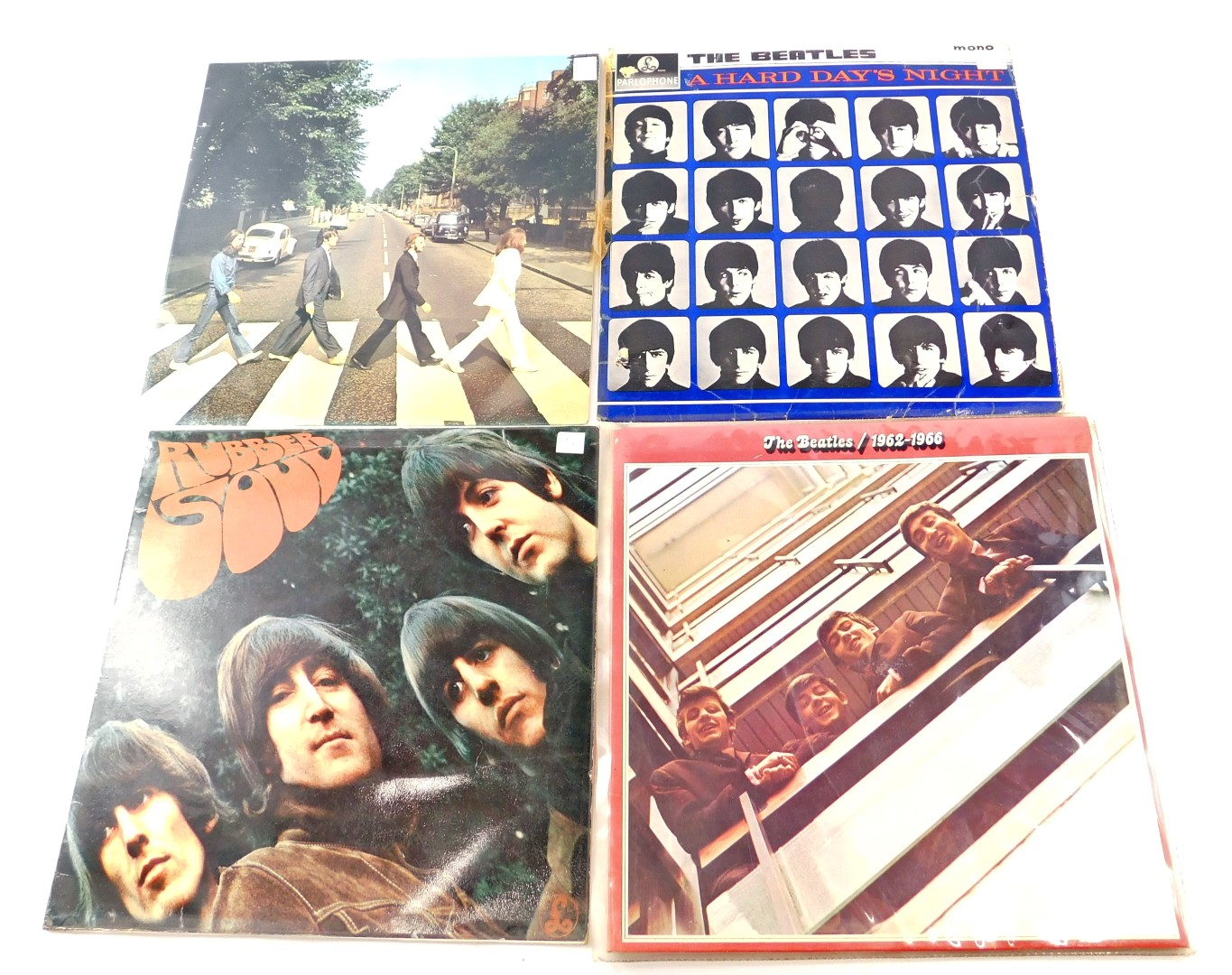 Four Beatles records, comprising The Beatles 1962-1966, Rubber Soul, Abbey Road, and Hard Days Night