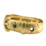 A 9ct gold buckle ring, set with one garnet and one vacant stone, maker JH, Birmingham 1909, misshap