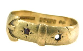 A 9ct gold buckle ring, set with one garnet and one vacant stone, maker JH, Birmingham 1909, misshap