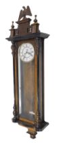 A late 19thC two weight Vienna wall clock, in a walnut case, the white enamel dial with Roman numera