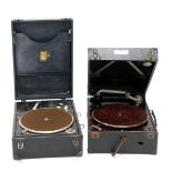 Two cased HMV portable record players.