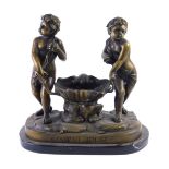 After Carrier Belleuse (French, 1824-1887) A bronzed metal sculpture of two figures beside a clam sh