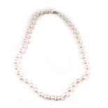 A pearl necklace, with white lustre finish beads, on a knotted string strand, of varying sizes, the