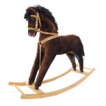 A brown plush rocking horse, with beech rockers, 107cm wide.