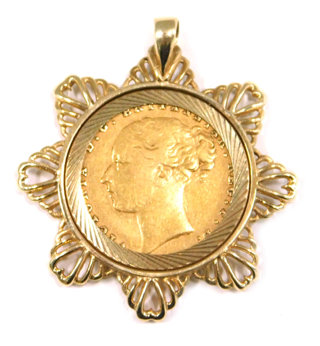 A young Victoria head full gold sovereign pendant, dated 1876, in a 9ct gold star mount, 12.3g all i