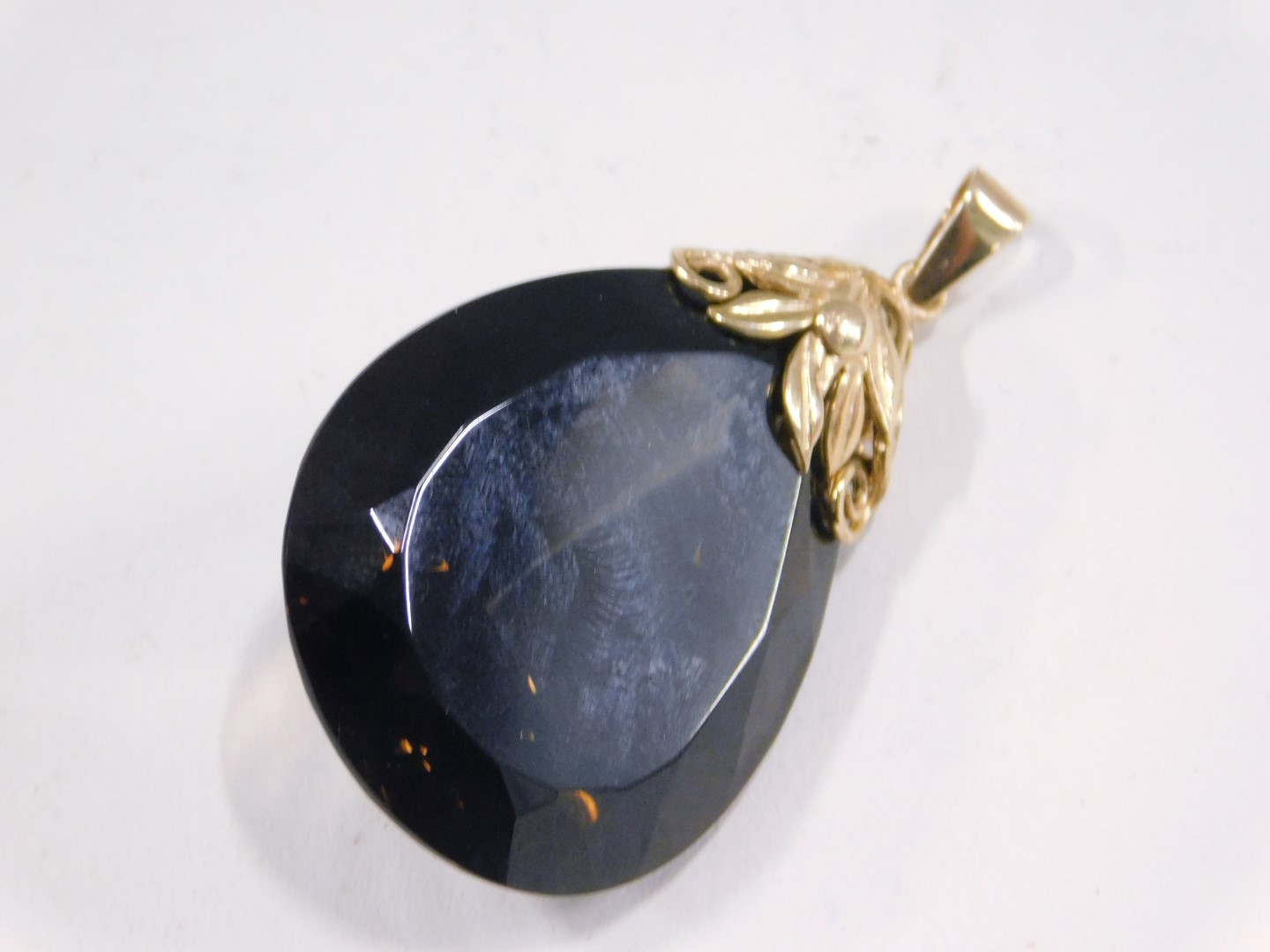 A smokey quartz pendant, the tear drop cut smokey quartz, 4cm high x 2.5cm wide, with a 9ct gold flo - Image 2 of 3