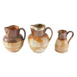 Three Doulton stoneware jugs, comprising one with silver plated collar, 18cm high, and two others, 1