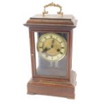 A 19thC continental mantel clock, the paper dial with Roman numerals, in a beech case, 35cm high.