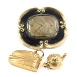 A Victorian memorial brooch and two charms, comprising a 19thC memorial brooch, in silver gilt with