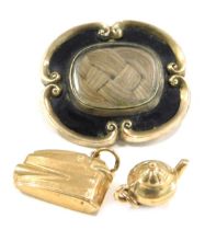 A Victorian memorial brooch and two charms, comprising a 19thC memorial brooch, in silver gilt with