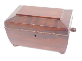 A Victorian mahogany sarcophagus shaped caddy, the hinged lid enclosing an interior with two smaller