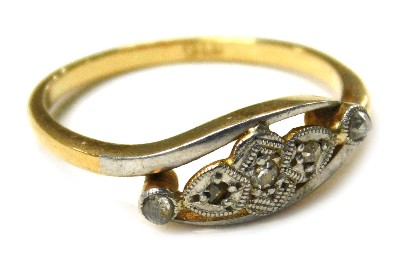 A 1920s diamond set twist ring, the central design set with five illusion set tiny diamonds, in plat