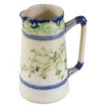 A Macintyre Burslem Company 19thC lemonade jug, with a dark blue border and green flowers, stamp to