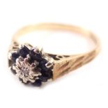 A 9ct gold floral cluster ring, set with eight point sapphire, and central CZ, with striped design s