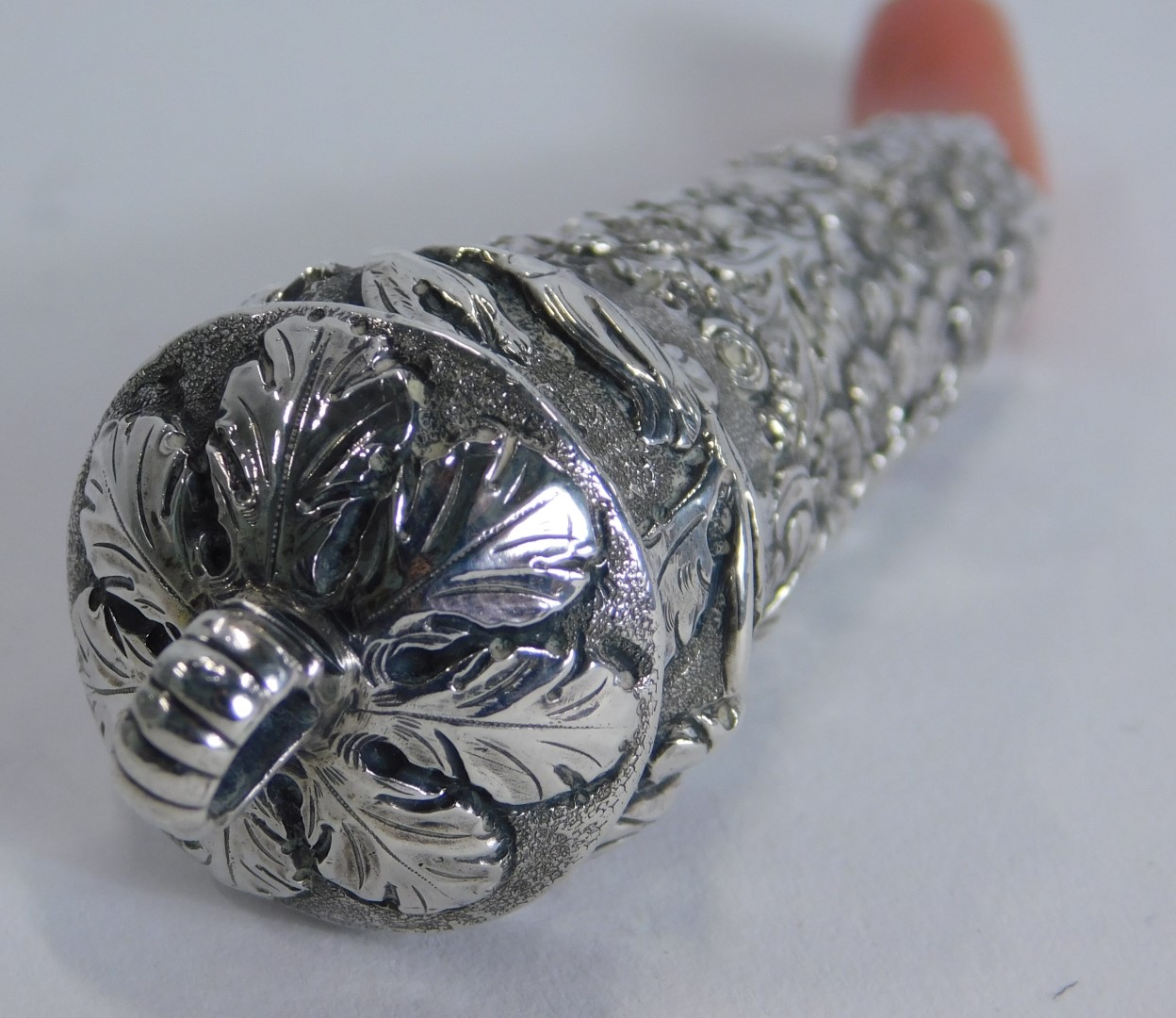 A Victorian teething rattle, with a coral base, with embossed floral top, white metal unmarked, 11cm - Image 2 of 3