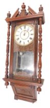 A 19thC American wall clock, with a painted dial, in carved walnut case, 106cm high. (AF)