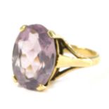A 9ct gold amethyst dress ring, the oval amethyst in four claw raised basket setting, 14mm x 10mm, r