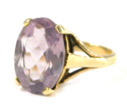 A 9ct gold amethyst dress ring, the oval amethyst in four claw raised basket setting, 14mm x 10mm, r