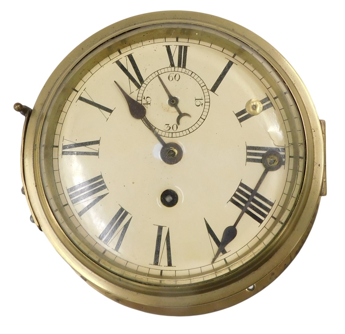 A brass ship's bulk head clock, with cream enamel dial, 24cm diameter. (AF)