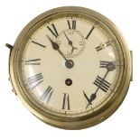 A brass ship's bulk head clock, with cream enamel dial, 24cm diameter. (AF)