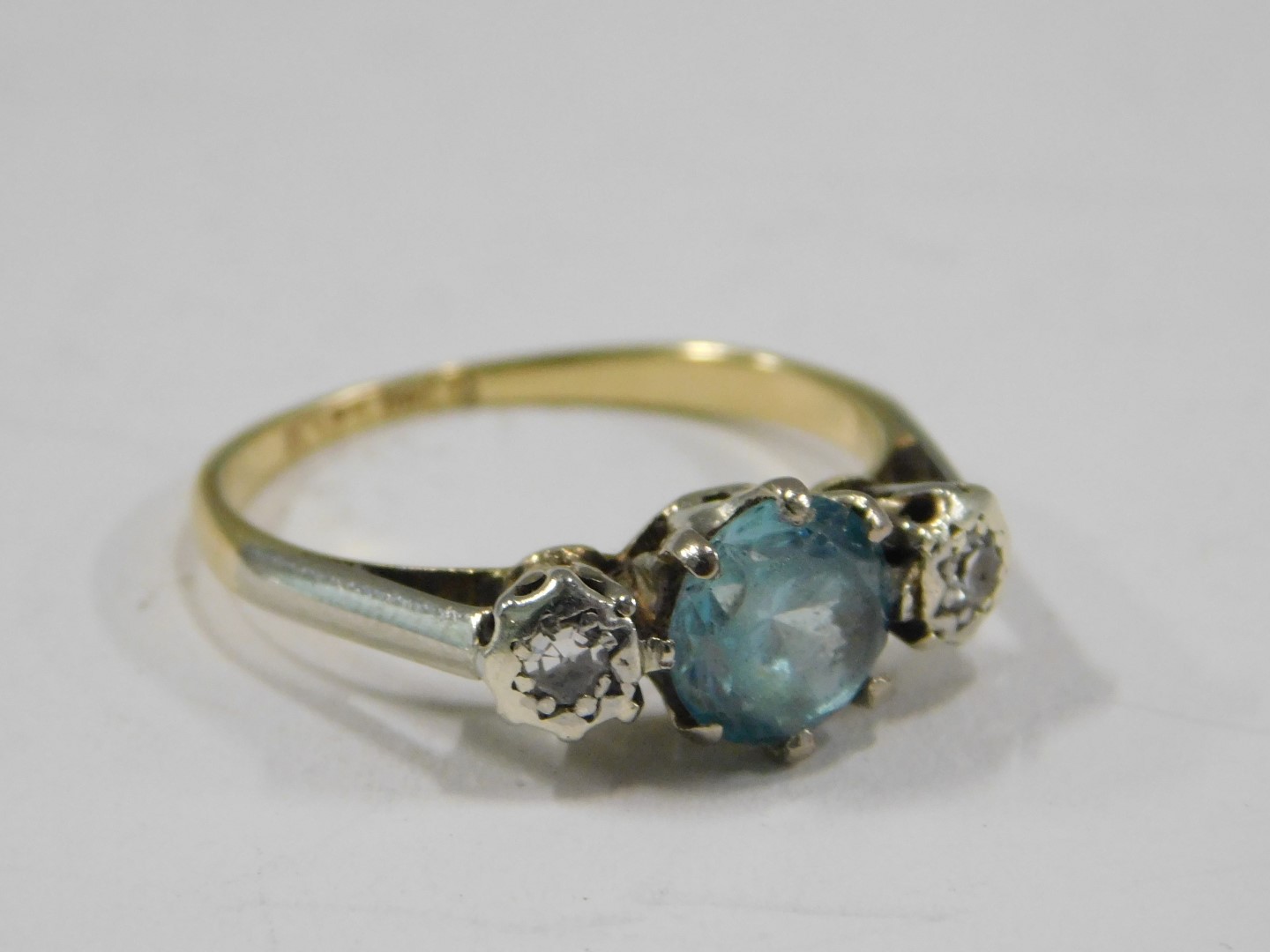 A blue zircon and diamond three stone dress ring, the central zircon in a six claw setting, flanked - Image 2 of 3