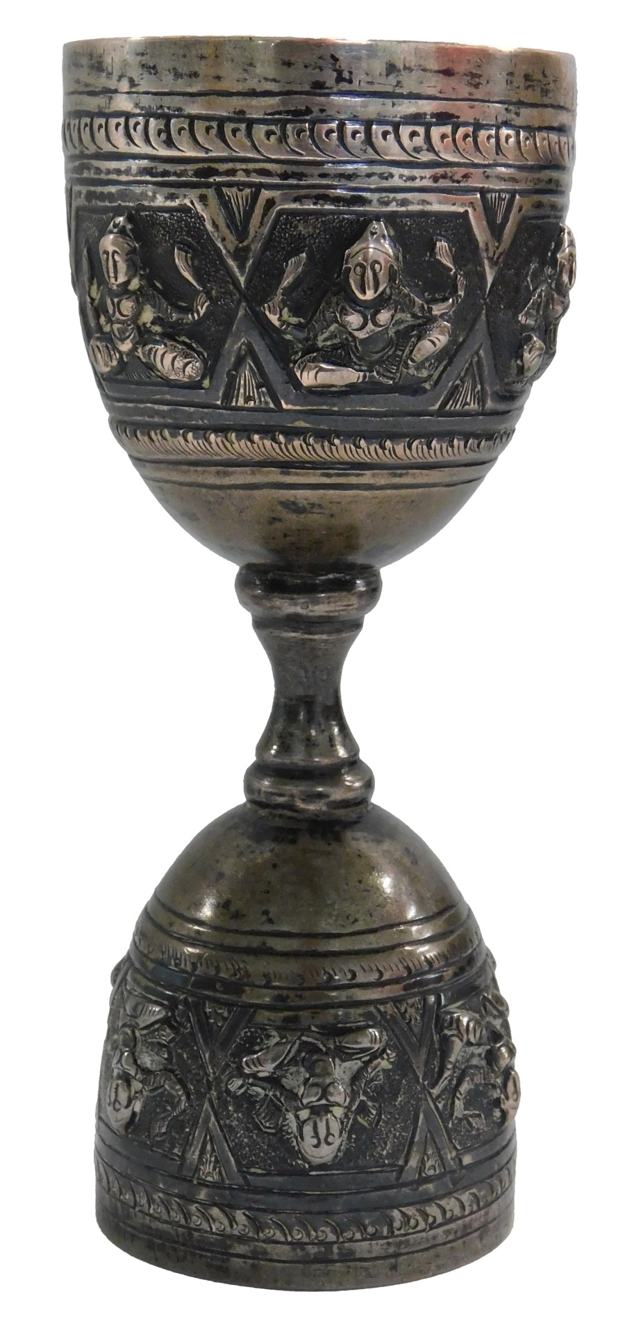 An Eastern hammered design goblet, with raised Buddhistic figures, on a hammered dot border, silver