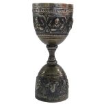 An Eastern hammered design goblet, with raised Buddhistic figures, on a hammered dot border, silver