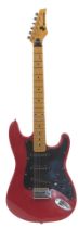 A Mustang Stratocaster style Japanese electric guitar, in red, 99cm long.