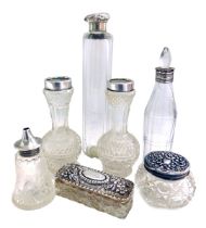 A group of silver topped dressing table jars, vinaigrette jar and perfume bottle. (7)