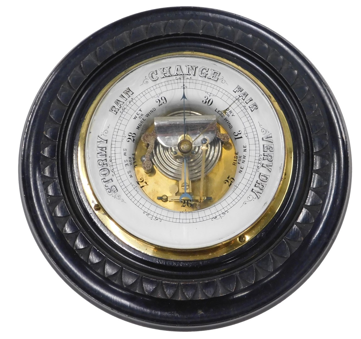 A late 19th/early 20thC ebonised aneroid barometer, with circular case, 21cm diameter.