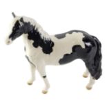 A Beswick pinto pony glazed figure, with black Beswick stamp to underside, 17cm high.