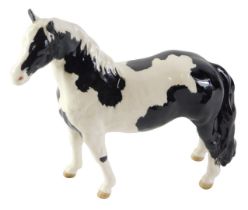A Beswick pinto pony glazed figure, with black Beswick stamp to underside, 17cm high.