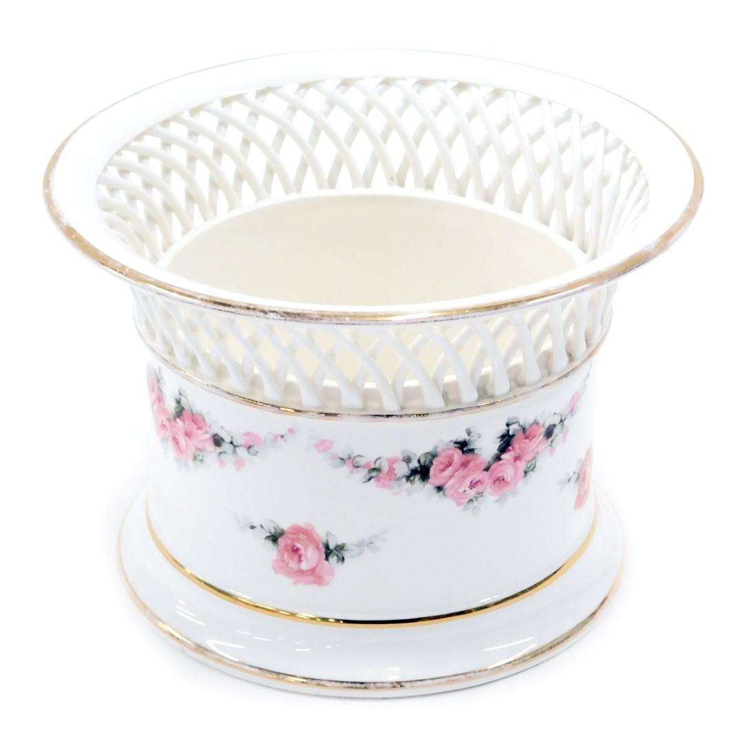 A Continental porcelain basket, with lattice border, and transfer printed decoration of roses, numbe