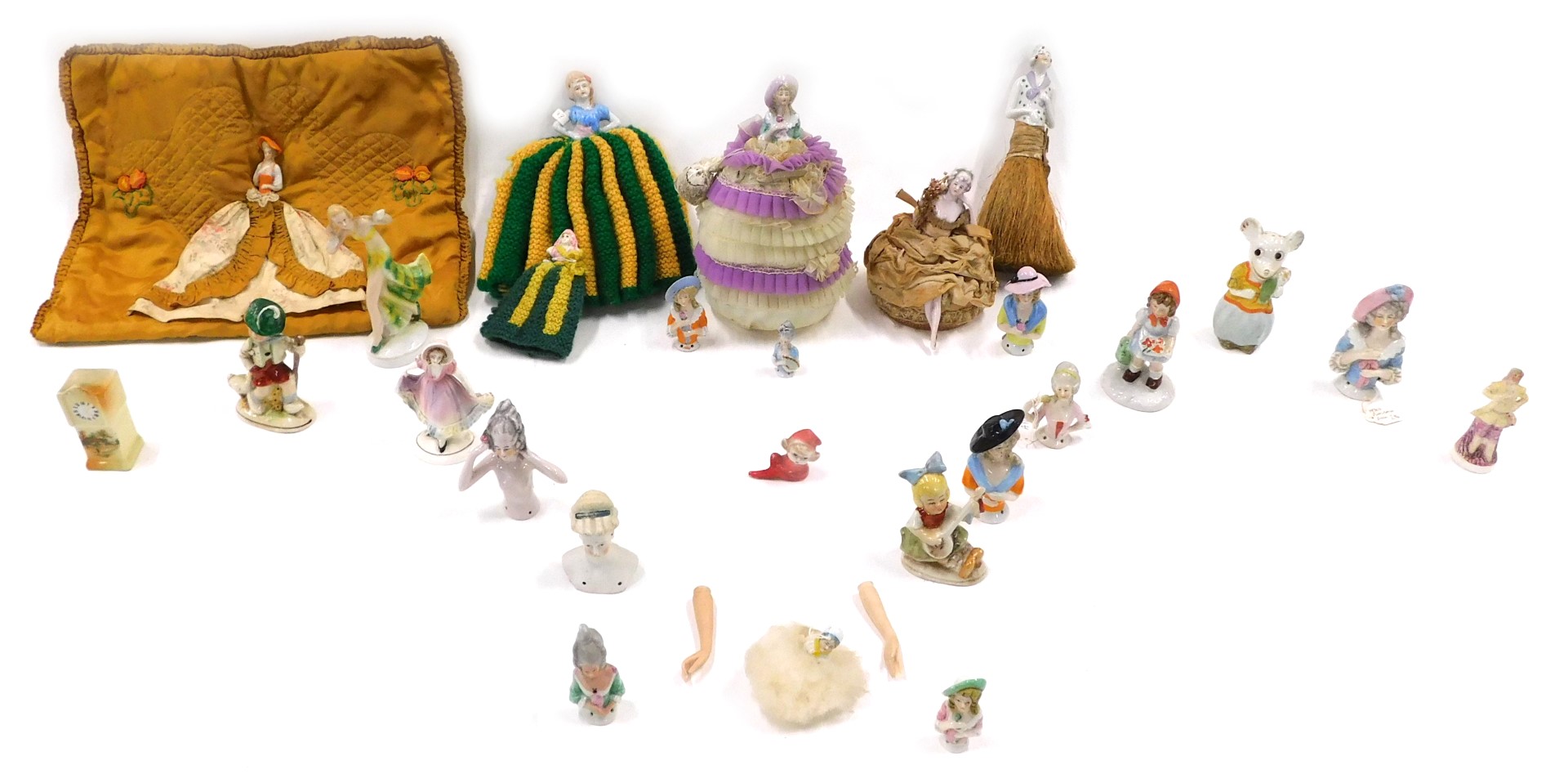 An early 20thC pin cushion doll and various other similar dolls, etc.