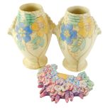 A pair of Kensington Art Deco vases, decorated with flowers, 23cm high, and a Beswick floral wall pl