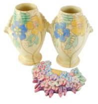 A pair of Kensington Art Deco vases, decorated with flowers, 23cm high, and a Beswick floral wall pl