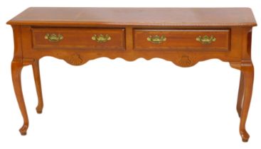 A reproduction walnut low serving or side table, the rectangular top with a moulded edge above two f