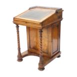 A Victorian walnut Davenport, the top with a pierced brass gallery, with later green leather inset,