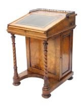 A Victorian walnut Davenport, the top with a pierced brass gallery, with later green leather inset,