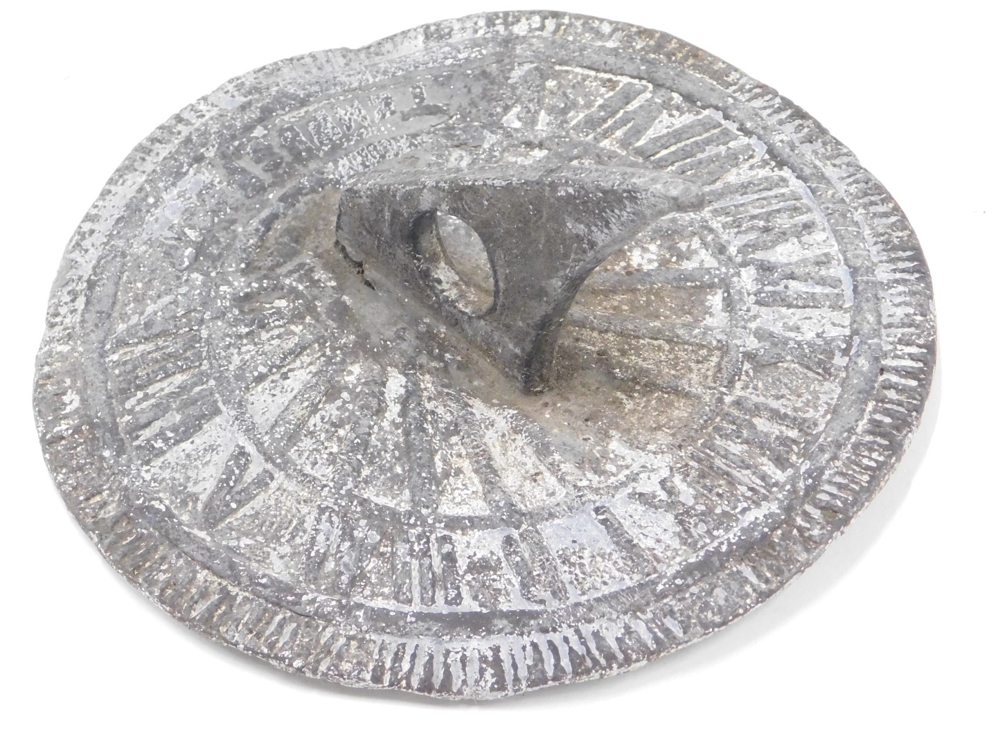 A lead sundial, with indistinct decoration, 17cm diameter.