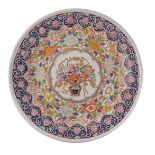 An oriental porcelain charger, decorated with flowers, leaves, etc., in polychrome enamels, pseudo m