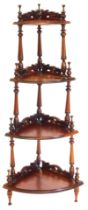 A Victorian style hardwood four tier corner whatnot, with pierced and carved galleries, with turned
