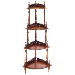 A Victorian style hardwood four tier corner whatnot, with pierced and carved galleries, with turned