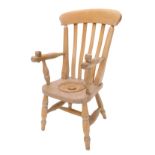 A child's commode chair, with slatted back, covered recess to elm seat, on turned legs with H stretc