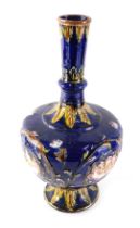 An EP.Co Staffordshire ceramic vase, decorated with pink flowers, on a blue ground within gilt borde