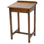 An oak child's desk, with hinged lid, on plain supports, 49cm wide.