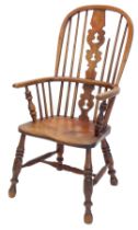 A late 19thC ash and elm Windsor chair with a pierced back splat, solid seat, on turned legs, with H