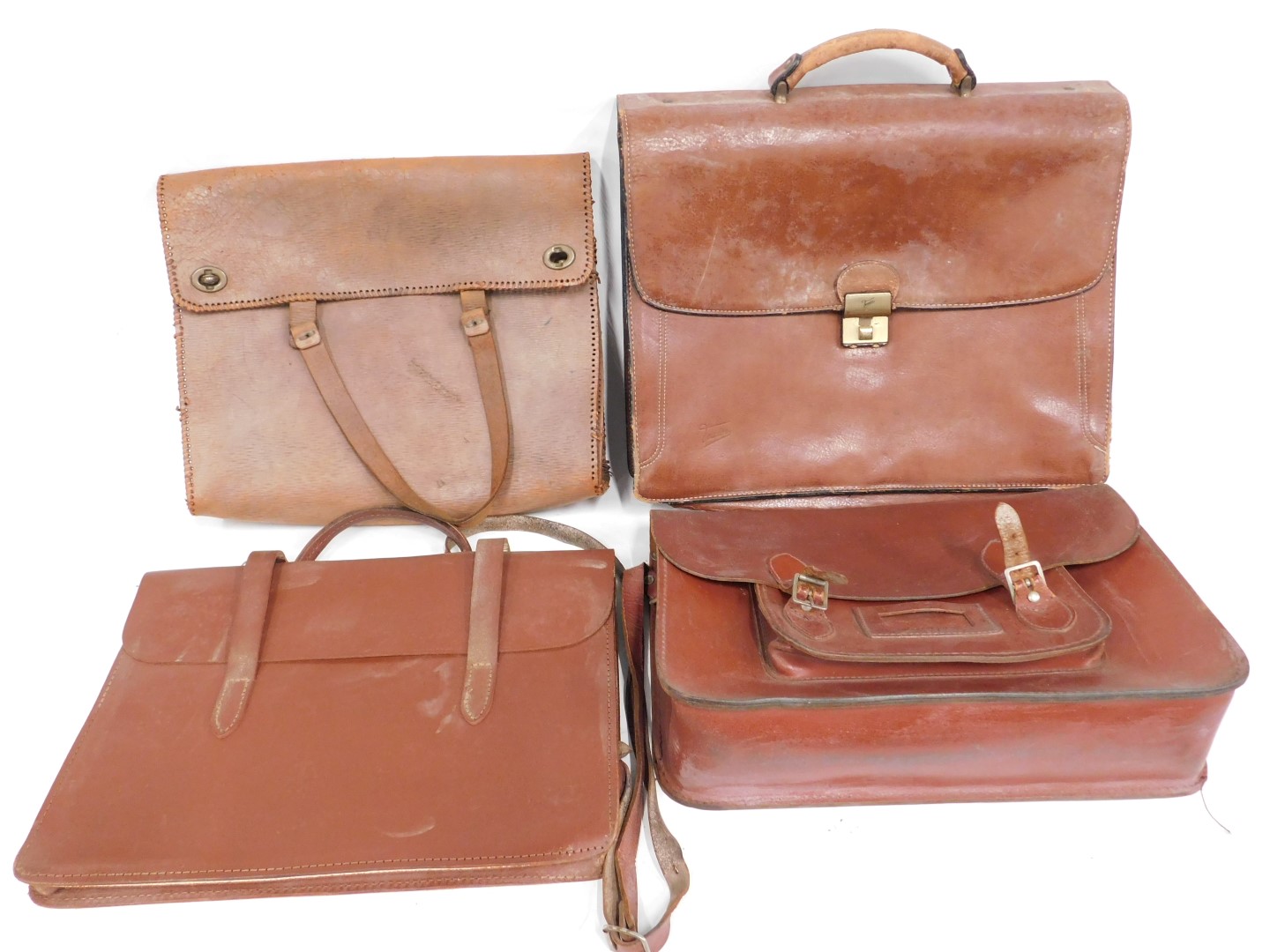 Four brown leather satchels.